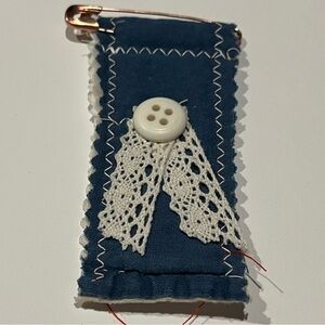 Navy quilted decorative patch.  The patch has a pin as closure.